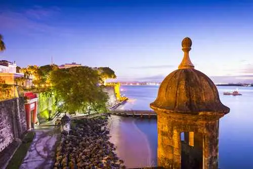 The enchanting blue hour over Old San Juan's Paseo de la Princesa at sunset, a perfect tropical postcard